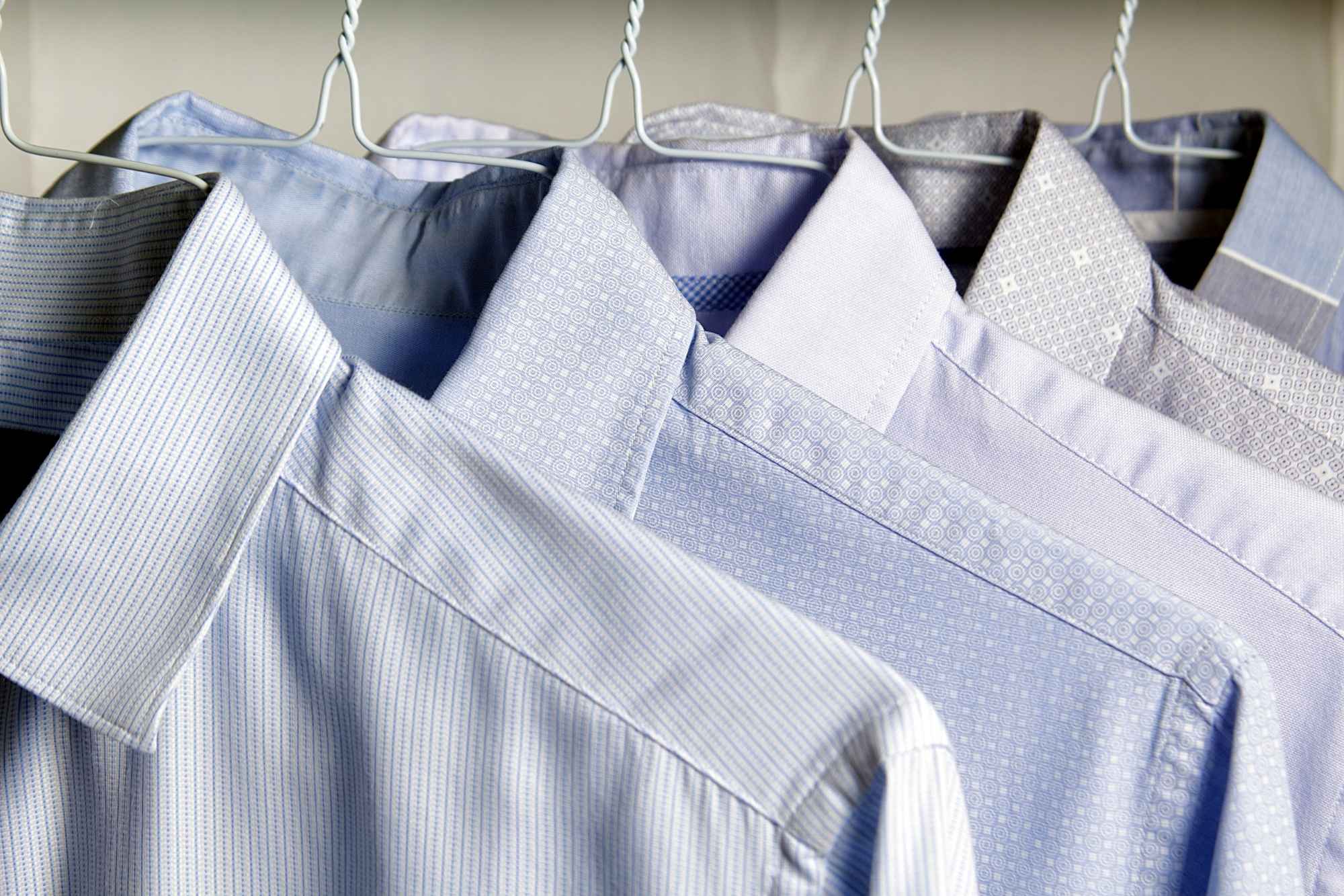 Four light blue and grey patterned dress shirts