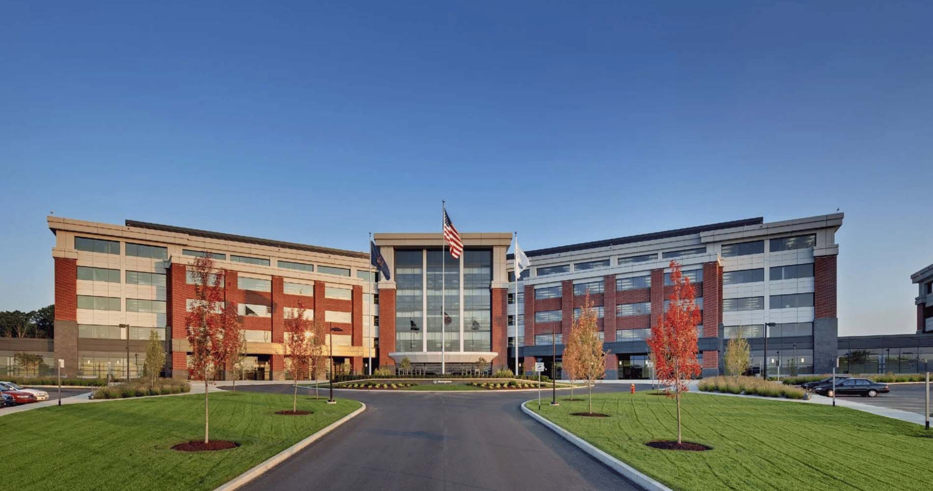A large, modern building with a red brick and glass facade